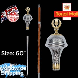May include: A silver and gold decorative walking stick with a brown wooden shaft and a decorative top. The walking stick is 60 inches long. The top of the stick has a thistle design.