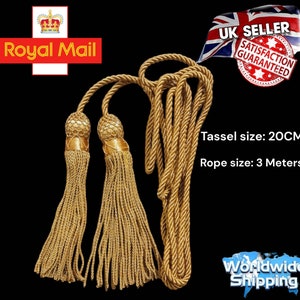 May include: Gold tassel rope with two tassels, each measuring 20 inches long. The rope is 3 meters long.  The tassels are made of gold thread and have a decorative knot at the top.  The rope is made of twisted gold cord.