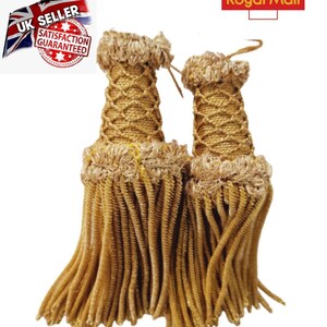 May include: Two gold tassel cords with a woven design and a fringe. The tassels are approximately 7.5 cm long.
