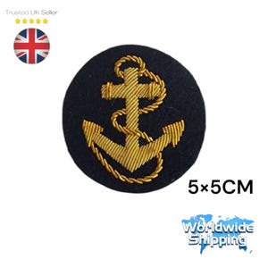 May include: A gold embroidered anchor on a navy blue felt circle. The anchor is 5 inches by 5 inches.