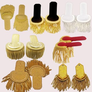 May include: Assortment of gold, white and red fringe trim in various shapes and sizes. The trim is made of woven fabric with a fringed edge.