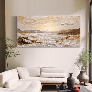 May include: A large horizontal landscape painting featuring a textured impasto technique in shades of cream, beige, white, and brown. The artwork depicts a coastal scene with rolling waves, rocky shorelines, and distant mountains under a bright sky.