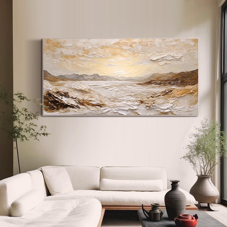 May include: A large horizontal landscape painting featuring a textured impasto technique in shades of cream, beige, white, and brown. The artwork depicts a coastal scene with rolling waves, rocky shorelines, and distant mountains under a bright sky.