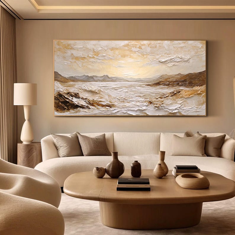 May include: A large rectangular landscape painting featuring a textured impasto technique in shades of cream, beige, white, and brown. The artwork depicts a serene coastal scene with rolling hills, rocky formations, and a bright, glowing horizon.