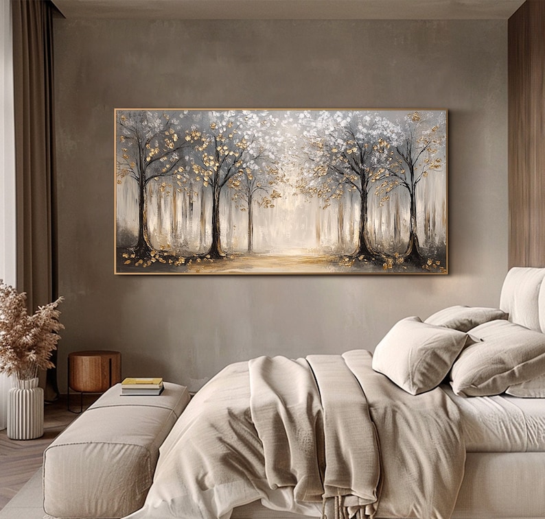 May include: A rectangular landscape painting featuring a forest scene with dark tree trunks, white foliage, and metallic gold leaf accents. The artwork displays a light-filled path in the center, rendered in shades of gray, white, and gold.