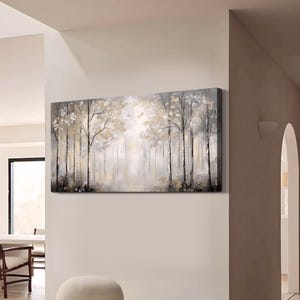 May include: A long, horizontal canvas painting depicting a misty forest scene. The trees are painted in shades of gray and brown, with hints of gold. The background is a soft, hazy white.