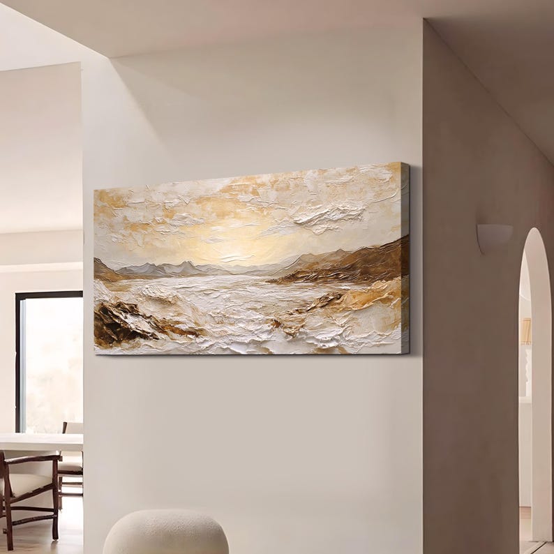 May include: A rectangular canvas wall art piece featuring a textured landscape painting. The artwork displays a horizon with mountains and a body of water in shades of white, cream, beige, and brown, created with thick, visible paint strokes.