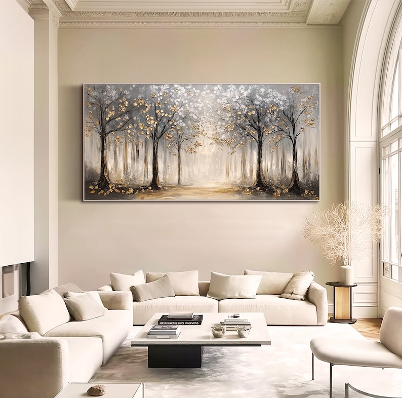 May include: A large rectangular wall art painting featuring a forest scene with dark tree trunks, white foliage, and metallic gold leaf accents. The composition displays a central path leading into a bright, hazy background with a neutral color palette.
