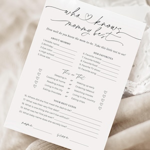 May include: A white paper game card with the text "who knows mommy best" in elegant script. The card includes fill-in-the-blank questions about the mom-to-be's preferences and personal details, perfect for a baby shower game.