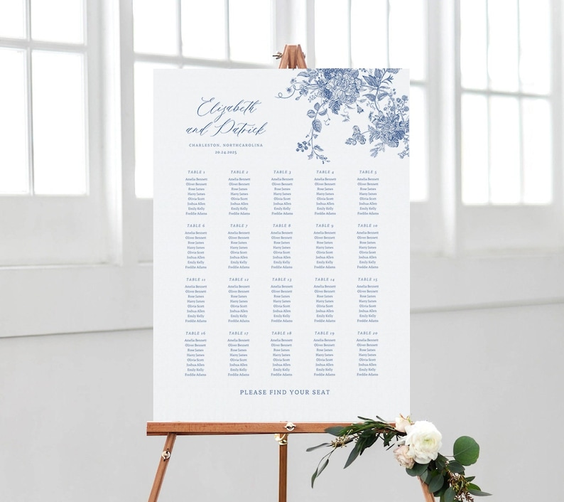 May include: A white wedding seating chart with a blue floral design at the top. The chart lists tables and guest names. The text at the top reads "Elizabeth and Patrick, Charleston, South Carolina, 09.24.2023". The bottom of the chart reads "Please find your seat."