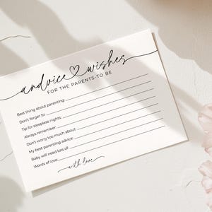 May include: A white card with the words "advice & wishes for the parents-to-be" in elegant script. The card has lines for advice, with prompts like "Best thing about parenting" and "Words of love."