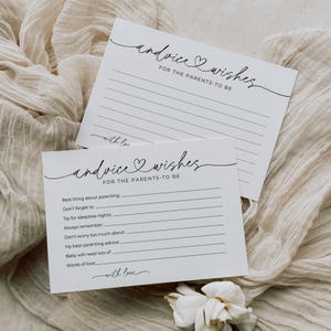 May include: Two white advice and wishes cards for parents-to-be. The cards have lined spaces for writing and are decorated with elegant script. The text on the cards includes "advice & wishes" and "for the parents-to-be."