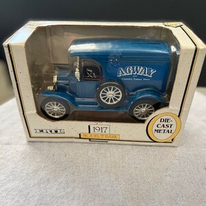 May include: A blue 1917 Model T bank by Ertl. The bank is die-cast metal and features the words "Agway Country Value Store" on the side.