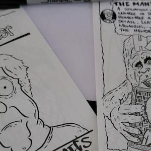 May include: Two black and white illustrations. One reads "missing hiker" above a cartoon portrait. The other depicts a large hairy creature holding a framed picture with the text "HARRY AND HENDERSONS" and "THE MANDELA EFFECT" above it.
