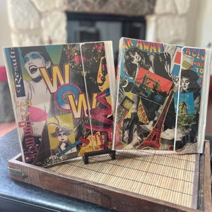 May include: Two rectangular binders featuring vibrant pop-art style collages. The left binder displays the text "RESULTS" and "WOW" with a portrait of a person. The right binder shows a collage with the Eiffel Tower, a windmill, and the text "FAR AWAY".