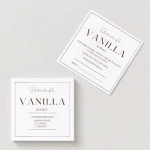 May include: Two white square labels with brown text. The labels read "Homemade Vanilla Extract" and include instructions for making vanilla extract with vodka and vanilla beans. The labels are for homemade vanilla extract.