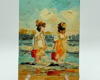Vintage small  oil painting on wood impressionist two toddlers girls on the beach holding red buckets with their feet in the water