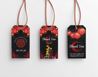 May include: Three black gift tags with red Chinese lanterns and calligraphy. The first tag says "MASCELERATION DINNER 08-04-26" with a Chinese symbol. The second tag says "Thank You from MANCA". The third tag says "Thank You You made tonight a hit! Enjoy this little treat!"