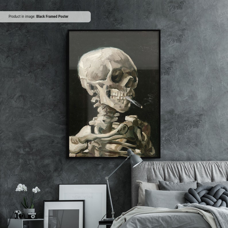 May include: A black framed poster featuring a painting of a white skeleton holding a cigarette in its mouth. The skeleton is depicted in a realistic style, with visible bones and a skull with a detailed face.
