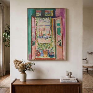 May include: A rectangular framed painting depicting an open window view with vibrant colors. The artwork features pink shutters, a green frame, and a scene of sailboats on water. Below the window, colorful potted plants are visible in a garden.