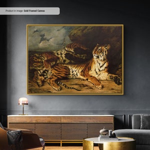 May include: A gold-framed canvas print featuring a detailed painting of tigers. The artwork depicts several tigers in a naturalistic setting, with rich brown and orange tones dominating the scene. The tigers are in various poses, creating a dynamic composition.