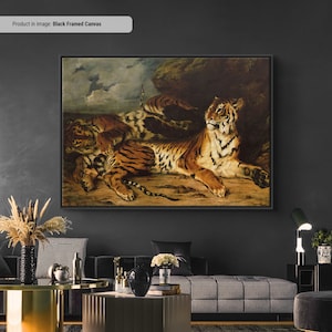 May include: Black framed canvas art featuring a detailed painting of tigers. The artwork depicts several tigers in a naturalistic setting, with a dominant tiger in the foreground. The tigers have orange and black stripes, with a neutral background.