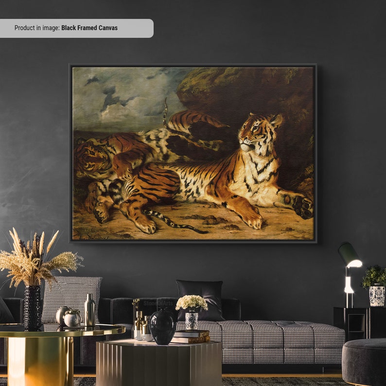 May include: Black framed canvas art featuring a detailed painting of tigers. The artwork depicts several tigers in a naturalistic setting, with a dominant tiger in the foreground. The tigers have orange and black stripes, with a neutral background.