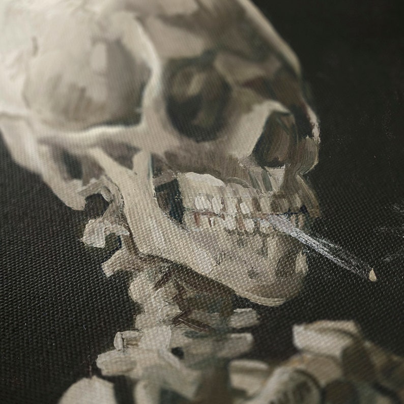 May include: A close-up of a painting depicting a human skull with a cigarette in its mouth. The skull is painted in a realistic style with visible teeth and a detailed jawline. The background is a dark, textured canvas.
