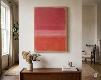 May include: A rectangular wall art piece featuring horizontal bands of color in shades of deep red, soft pink, and vibrant orange, enclosed within a light-toned wooden frame. The artwork displays a textured, layered paint application.