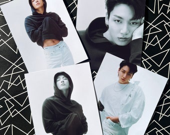 May include: Four black and white photos of a person wearing a black hoodie and white jeans. The person is posing in different ways in each photo.