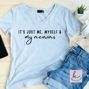 May include: A light gray V-neck t-shirt with the text "It's just me, myself & my neurons" printed in black.