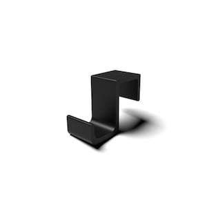 May include: A matte black metal over-the-door hook featuring a squared, S-shaped profile. The design includes a flat top section for mounting over a door edge and a curved lower section that forms a sturdy hook for hanging various household items.