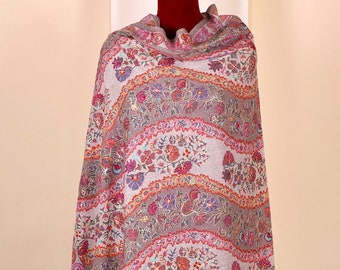 May include: A gray shawl with a colorful floral pattern. The shawl is draped over a mannequin and is displayed on a white background.
