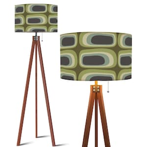 May include: Two wooden tripod floor lamps. The lampshades feature a retro pattern of olive green, gray, and light blue ovals. The wooden legs are a dark brown color, and the lamps have a pull chain.