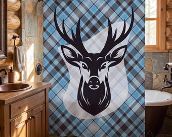 May include: A shower curtain featuring a large, centered black graphic of a deer head with antlers set against a light blue, dark blue, and white diagonal plaid pattern. The design is printed on a rectangular fabric panel with metal grommets.
