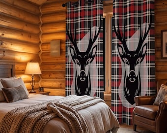 May include: A pair of floor-length window curtains featuring a red, black, and white plaid pattern with a large, stylized black deer head graphic printed on each panel. The curtains are hung on a dark rod with integrated metal grommets.