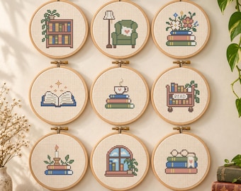 May include: Nine circular wooden embroidery hoops containing cross-stitch patterns of reading-themed items including a bookshelf, armchair, flowers on books, an open book, a coffee cup on books, a book cart, a candle, a window, and glasses on books.