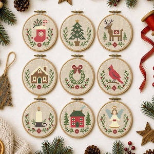 May include: Nine circular wooden embroidery hoops containing cross-stitch patterns featuring Christmas themes including a stocking, tree, reindeer, gingerbread house, wreath, cardinal, candle, cottage, and angel on light fabric.