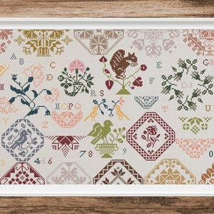May include: Framed cross-stitch sampler with a variety of floral, animal, and geometric patterns in a palette of muted colors. The design includes a squirrel, birds, and floral motifs, with letters and numbers.