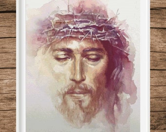 May include: A watercolor painting of a man's face with a crown of thorns. The man's eyes are closed and his expression is peaceful. The background is a soft purple and pink.