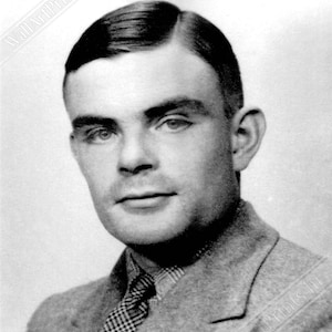 May include: Black and white portrait photograph of a man with short, dark hair combed to the side. He is wearing a suit jacket with a patterned tie.