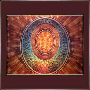 May include: A circular, multi-colored, mandala-like design with a central, bright orange and red circle. The design is surrounded by concentric circles of blue, green, and gold.