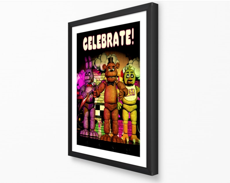 May include: Framed print featuring the characters from the video game Five Nights at Freddy's. The image shows Freddy, Bonnie, and Chica with the word "CELEBRATE!" at the top. The characters are set against a stage background.