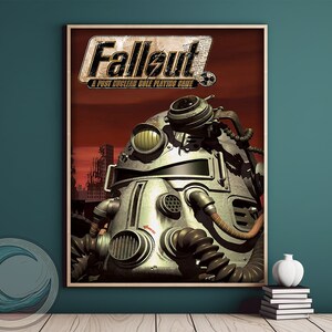 K&ouml;nnte beinhalten: Ein gerahmtes Poster mit dem Videospiel Fallout. Das Kunstwerk zeigt eine detaillierte Illustration eines Roboterhelms mit verschiedenen Rohren und L&uuml;ftungsschlitzen vor einem roten, apokalyptischen Hintergrund. Der Titel des Spiels ist oben auf dem Poster zu sehen.