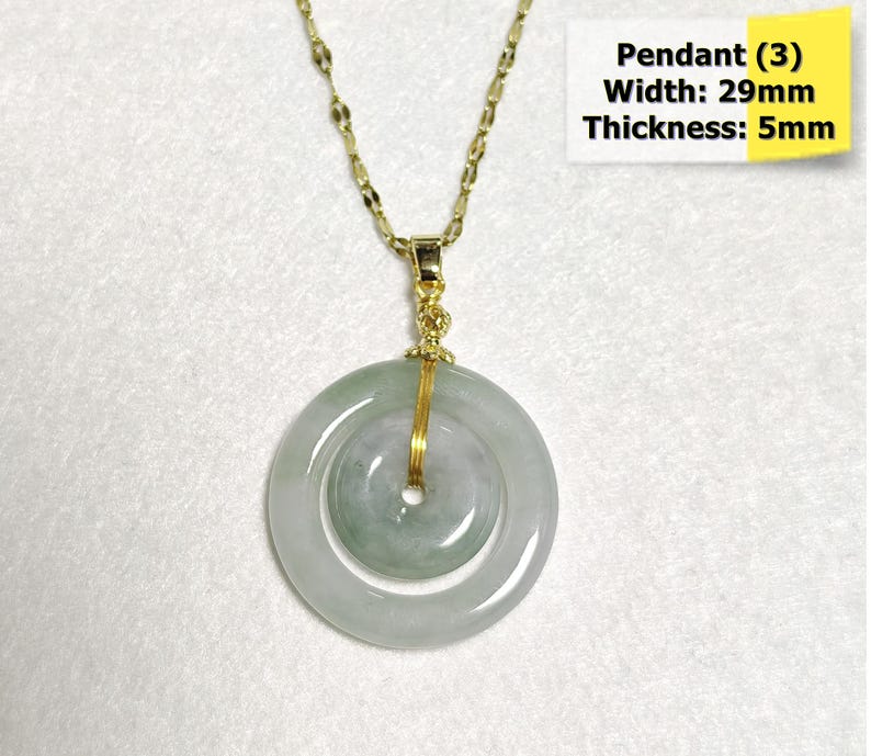 May include: A gold-colored necklace with a jade pendant. The pendant is a light green and white circular design, 29mm wide and 5mm thick. The text on the image reads "Pendant (3) Width: 29mm Thickness: 5mm."