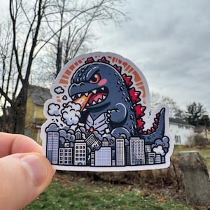 Cute Chibi Godzilla Destroying The City Sticker - Adorable Kaiju Monster Vinyl Decal for Laptops, Water Bottles, and More