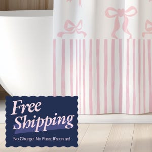 May include: White shower curtain with a pattern of pink bows and vertical pink stripes. The curtain is hanging in front of a white bathtub. The words "Free Shipping" are displayed on a dark blue sign.
