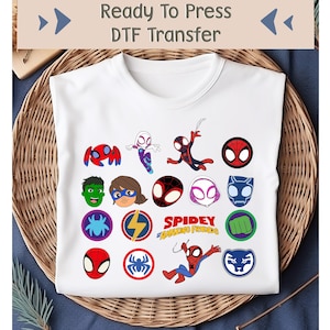 May include: White t-shirt featuring colorful cartoon images of Spider-Man characters and the text "Spidey and His Amazing Friends." The shirt also has the text "Ready To Press DTF Transfer" at the top.
