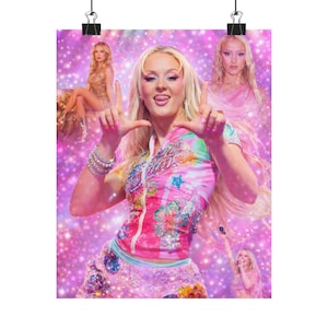 May include: A poster featuring a pop star in a pink and colorful outfit, with multiple images of the same person. The background is a sparkling pink, with the main subject making a hand gesture.