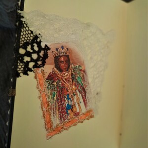 May include: A vintage-style image of a woman wearing a crown and ornate clothing, framed with lace and a decorative border.